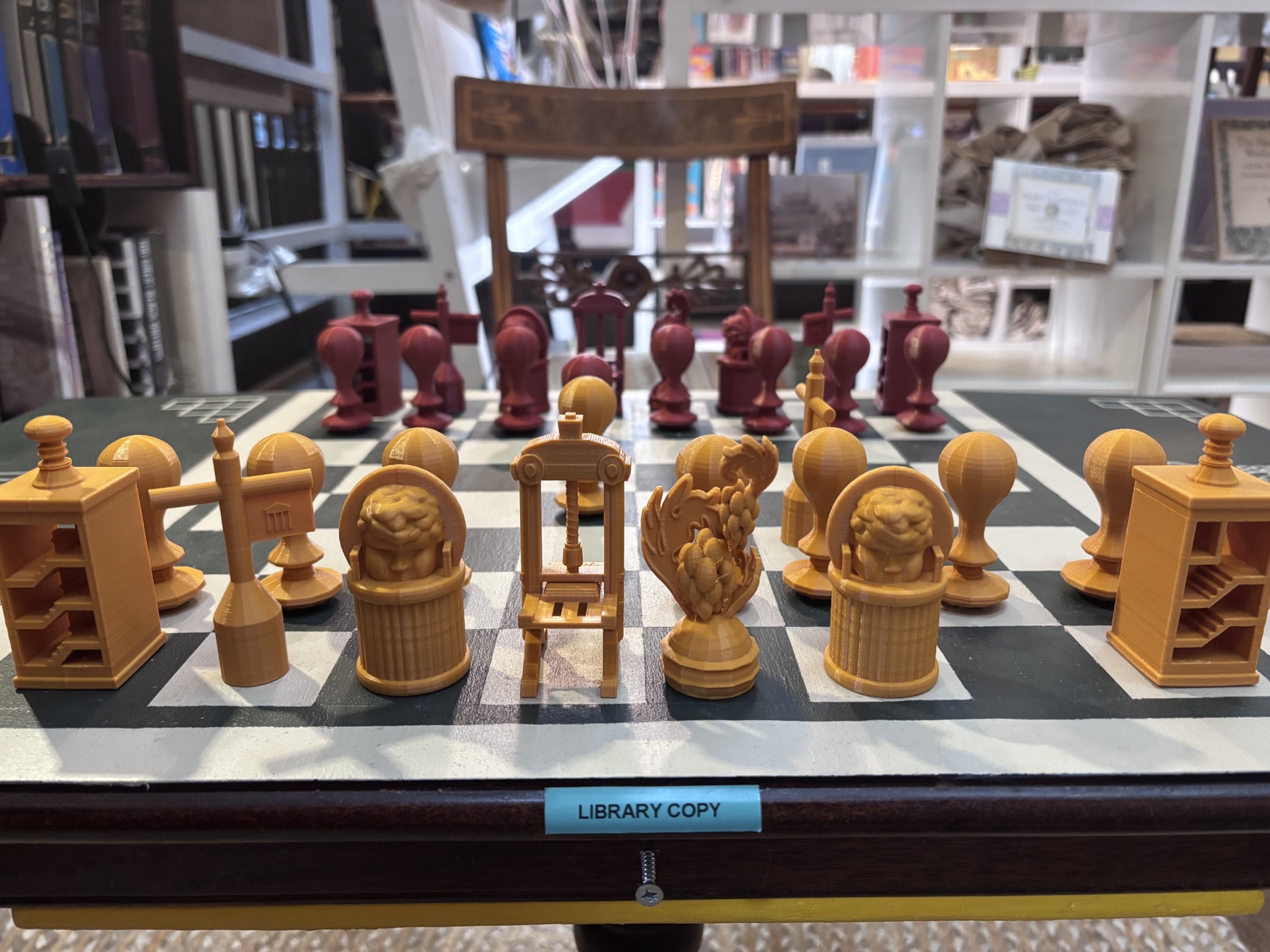 An architectural chess set displayed in a library